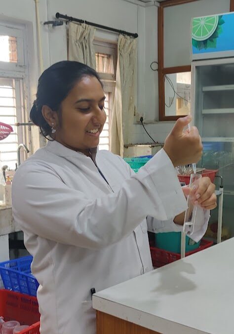 Mitali testing water using the ENPHO's water testing kits.