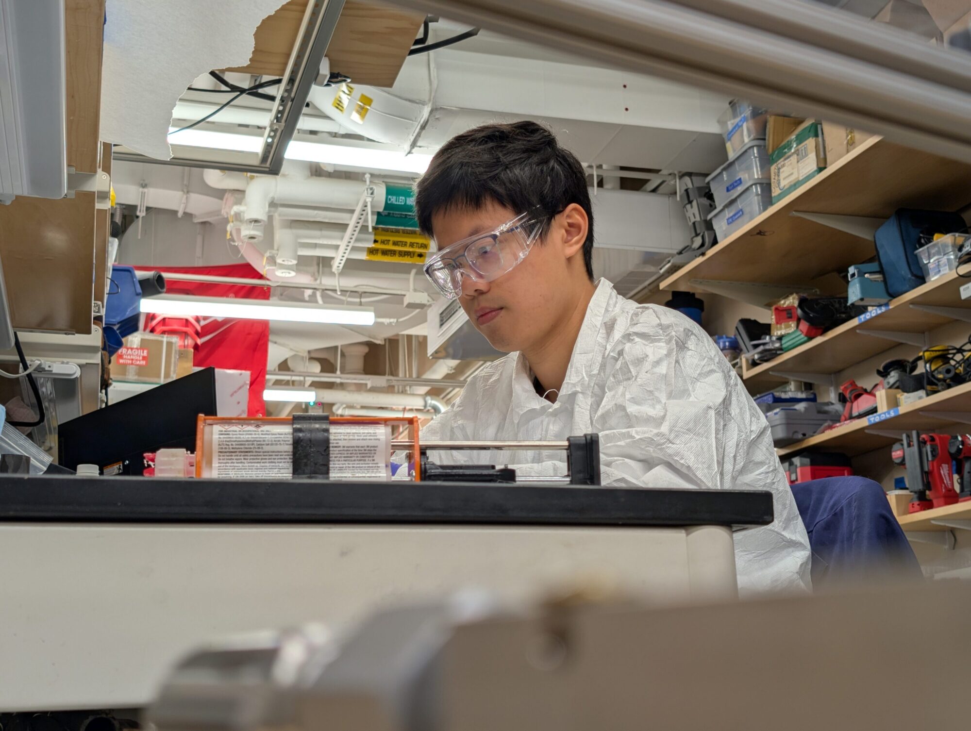 ZhiYi Liang assembling prototypes in the lab. Photo by Andy Tzu-Ching Chen.