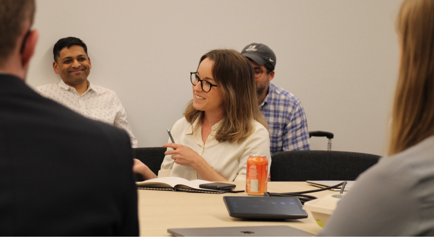 Michelle interacting with member companies at an in-person meeting.