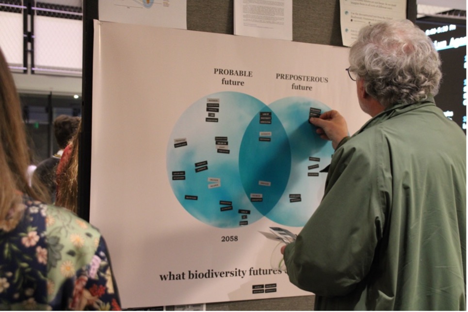 Industry representatives and members of the MIT community interacting with Michelle’s research at the MCSC Annual Symposium’s poster session.